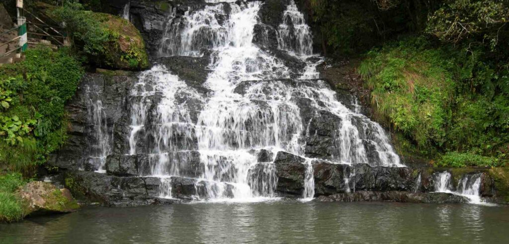 Elephant Waterfall in Shillong, surrounded by greenery, during the Cherry Blossom Festival.